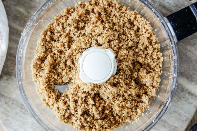 overhead view of pecan pie crust ingredients blitzed in a food processor