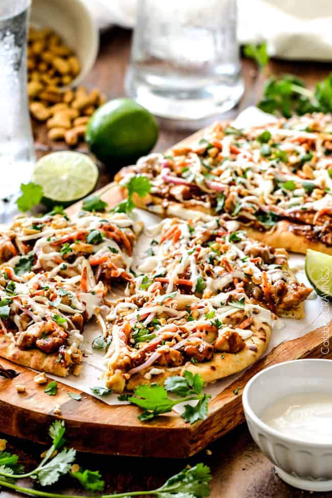 CPK inspired 20 Minute Thai Chicken Flatbread Pizza smothered in easy tangy peanut sauce, tender chicken, mozzarella cheese, crunchy carrots, sprouts and peanuts and the option of creamy coconut yogurt drizzle - an amazing flavor bursting quick dinner at a fraction of the cost.