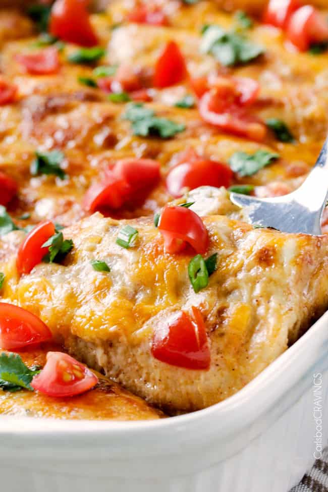 Easy, hearty Breakfast Enchiladas stuffed with your favorite breakfast ingredients then smothered with intoxicatingly delicious Creamy Salsa Sauce! These enchiladas are totally customizable, perfect for your leftover holiday ham AND you can assemble the night before and bake the next day! up close of easy breakfast enchiladas with sausage and poatotes