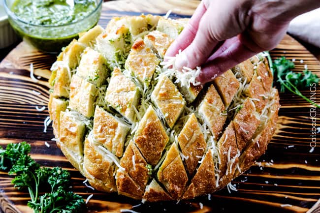 showing how to make cheesy pull apart bread by stuffing cheese in between the bread slices