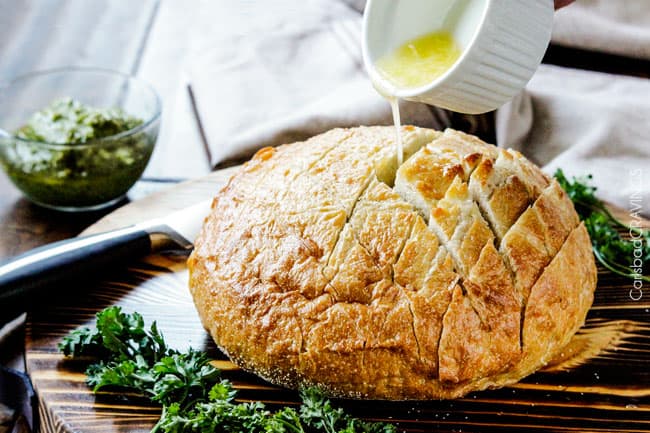 showing how to make pull apart bread by pouring butter in between bread slices