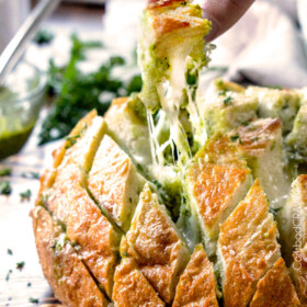 4 Ingredient, make ahead Cheesy Pull Apart Pesto Bread will make your life easier and all your parties more delicious!
