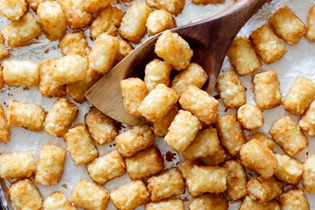 Easy, hearty Breakfast Enchiladas stuffed with your favorite breakfast ingredients then smothered with intoxicatingly delicious Creamy Salsa Sauce! These enchiladas are totally customizable, perfect for your leftover holiday ham AND you can assemble the night before and bake the next day! showing how to make breakfast enchiladas by cooking tater tots