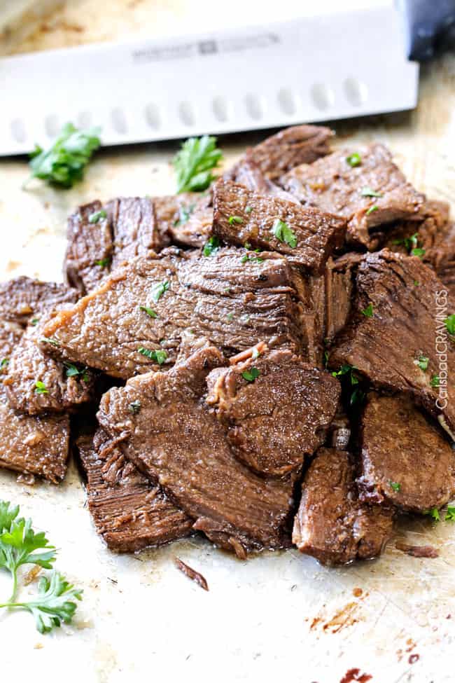 5 minute prep Crazy tender Slow Cooker French Dip Sandwiches seeping with spices are unbelievably delicious and make the easiest dinner or party food. You haven't had French Dip Sandwiches until you try these! Sliced Slow Cooker French Dip Sandwiches meat.