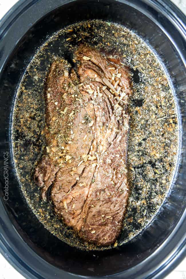 5 minute prep Crazy tender Slow Cooker French Dip Sandwiches seeping with spices are unbelievably delicious and make the easiest dinner or party food. You haven't had French Dip Sandwiches until you try these! Showing how to cook the beef for Slow Cooker French Dip Sandwiches.