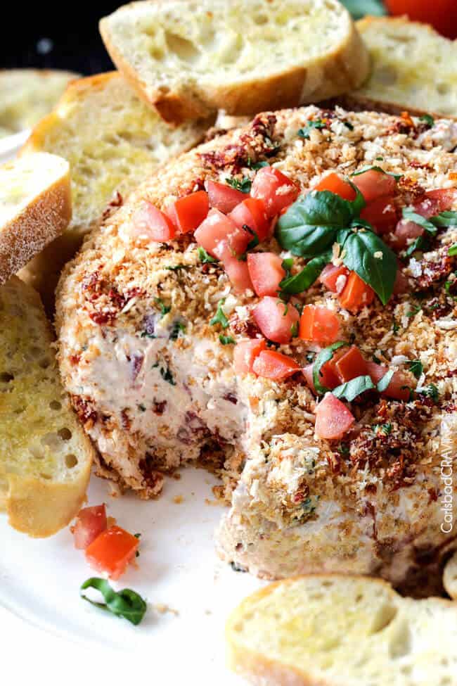 Super easy Bruschetta Cheese Ball takes just minutes to whip up and is always a total show stopper, make ahead appetizer! Loaded with fresh tomatoes, sun-dried tomatoes, fresh basil and garlic and herb cream cheese then rolled in crispy panko breadcrumbs all served with toasted baguette slices! So irresistibly delicious!