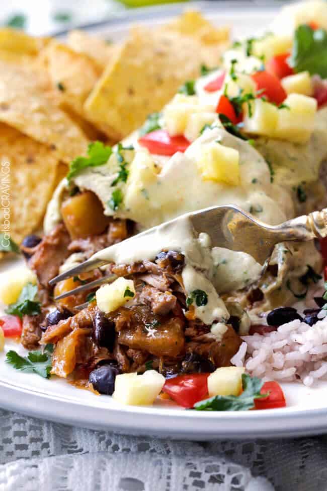 Close up of Slow Cooker Pineapple Salsa Pork with a fork taking a bite.
