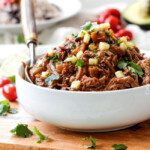 Slow Cooker Sweet and Spicy (optional) Pineapple Salsa Pork - crazy good EASY, flavorful filling for burritos, tacos, burrito bowls, salads, etc. I love making this for company because its SO good and SO easy!