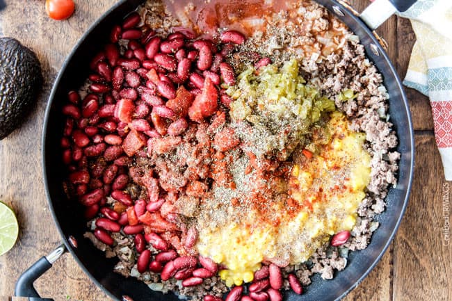 showing how to make taco pasta by adding hamburger, beans, enchilada sauce and corn to a skillet