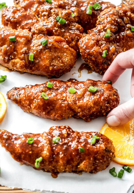 Tender, juicy Baked Orange Chicken Tenders are marinated and smothered in the most tantalizing sweet heat orange sauce you can't even imagine! You will crave this over your favorite Chinese orange takeout!