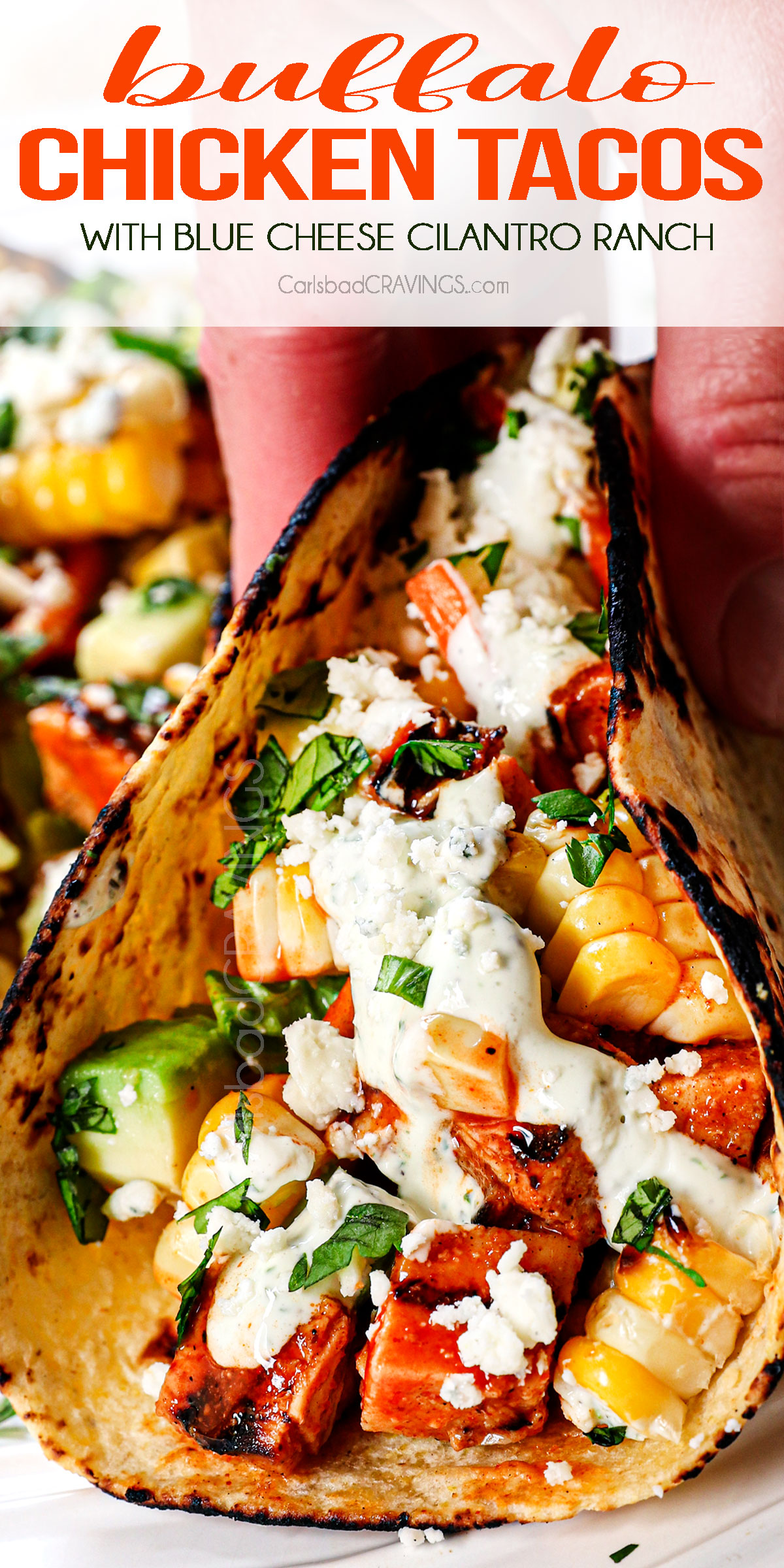 up close of holding buffalo chicken tacos showing the juicy chicken