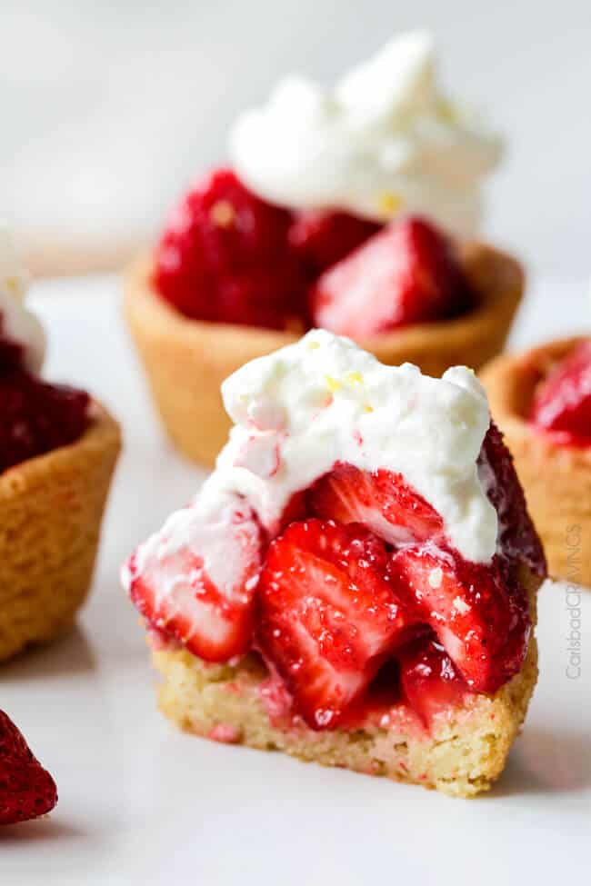 Showing how to make Mini Strawberry Pies with Sugar Cookie Crust by cutting one in half to see the layers.