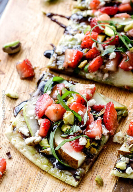 this fresh, sweet and salty Strawberry Pear Pesto Flatbread with Balsamic Reduction Drizzle smothered in brie cheese and garnished with feta and pistachios is OUT OF THIS WORLD! and super easy! Amazing appetizer, brunch or lunch! #Easter #Christmas #holiday
