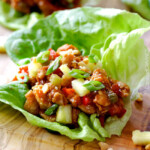 Quick and easy Asian Chicken Lettuce Wraps smothered in an unbelievable Pineapple Hoisin Peanut Sauce are 1000X better than takeout and on your table in under 30 minutes!