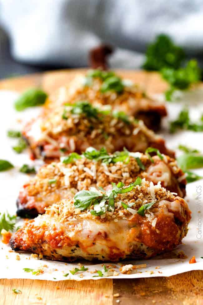 Skinny Chicken Parmesan cooked with herbs on top.