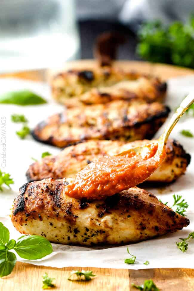 Showing how to make Skinny Chicken Parmesan adding sauce on top. .