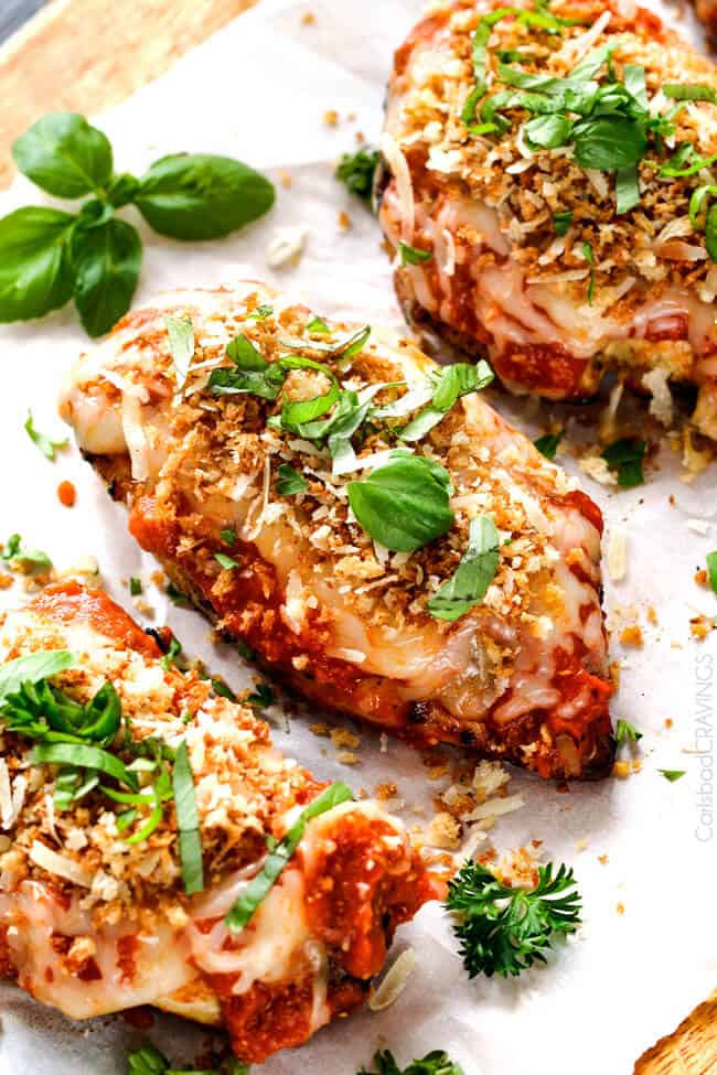 Top view of Skinny Chicken Parmesan on a white plate with basil garnish.