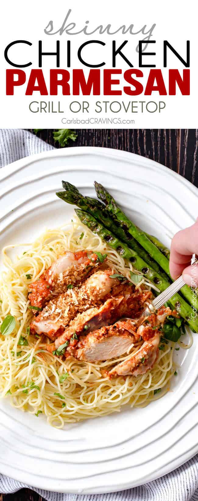 Skinny Chicken Parmesan on a white plate with asparagus.
