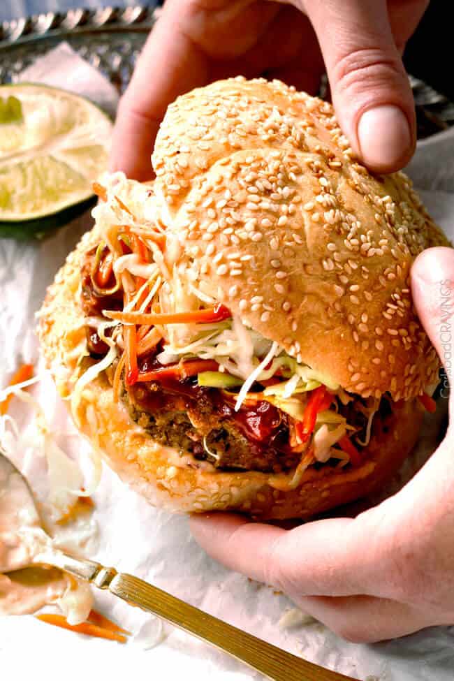 Holding a Asian Burger with Hoisin Ketchup & Garlic Chili Mayo.