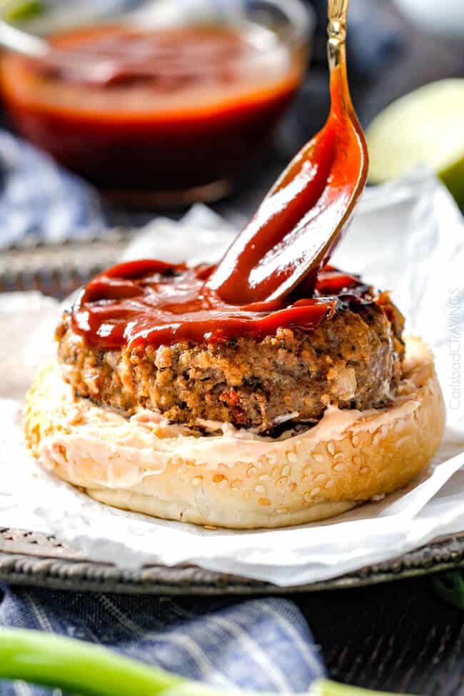 Adding sauce to the Asian Burger with Hoisin Ketchup & Garlic Chili Mayo