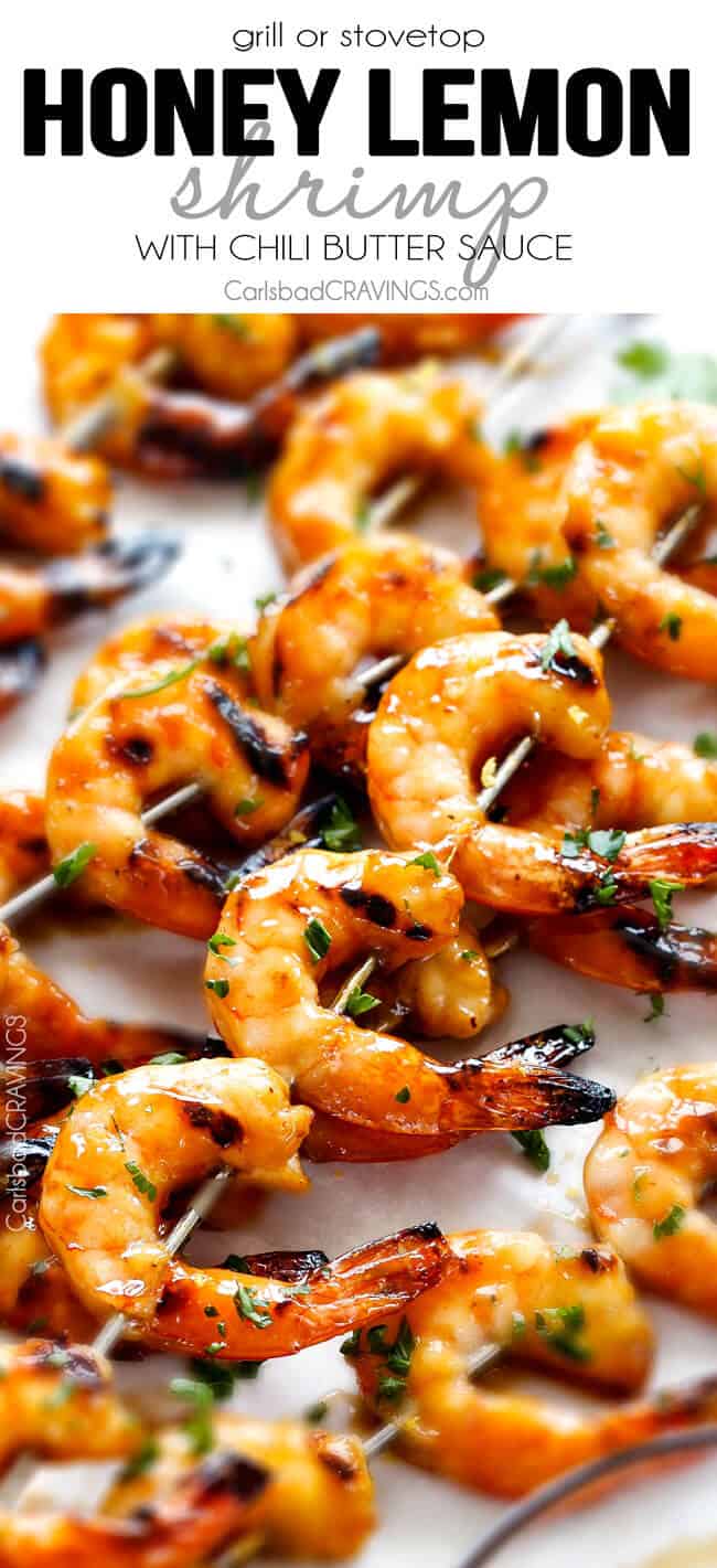 Asian Honey Garlic Shrimp - this is the easiest, most delicious sweet and tangy shrimp and you can make it on the grill or stovetop! and the Honey Lemon Chili Butter Sauce is out of this world! up close of Honey Garlic Shrimp on skewers on white parchment paper