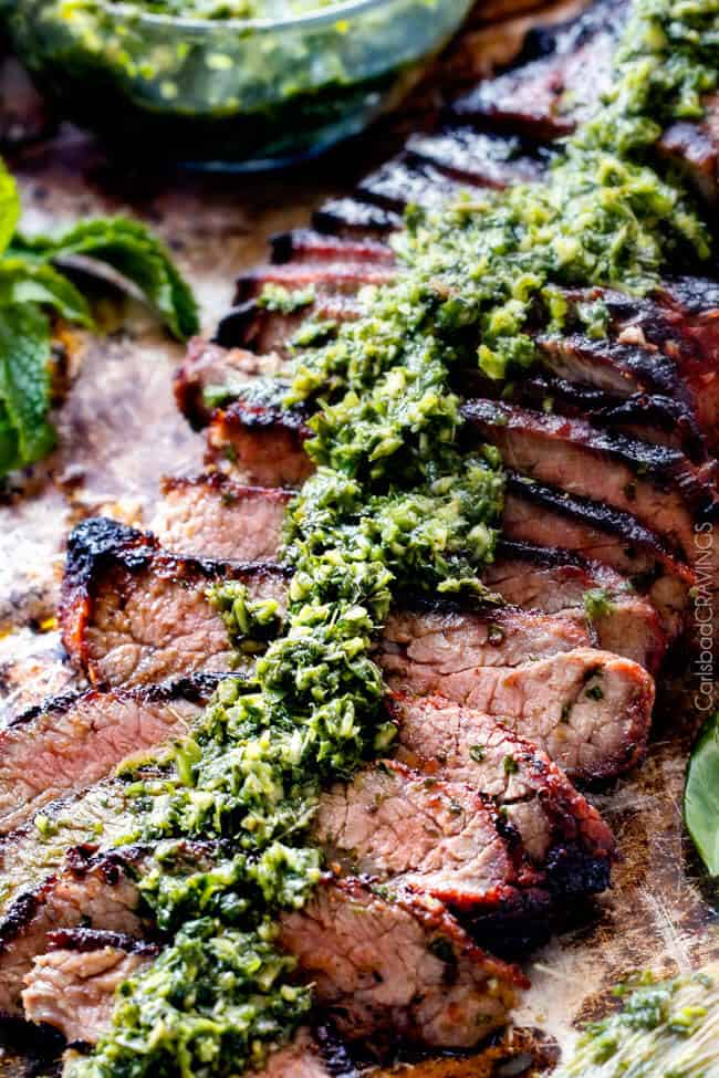 Close up of Grilled Asian Steak with Chimichurri sauce on top.