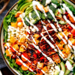 Preheat oven to 375 degrees. Using a large, sharp knife, trim ends; halve squash crosswise to separate bulb from neck. Peel with a vegetable peeler. Cut both pieces in half lengthwise. With a spoon, scoop out seeds; discard. Cut squash into 2-inch chunks; transfer to a small rimmed baking sheet. Toss with oil and sage; season generously with salt and pepper. Scatter garlic around squash. Roast until squash is very tender, about 40 minutes, tossing once halfway through. Remove and discard skin from garlic. Transfer squash and garlic to a food processor; puree. With motor running, add half-and-half through the feed tube; process until smooth. Add 1 to 2 cups water; continue to process until smooth, adding water to thin if necessary. Season again generously with salt. (To freeze, see below.) Cook pasta according to package instructions. Reserve 1 cup pasta water; drain pasta and return to pot. Pour sauce over pasta; toss to coat. Add some pasta water to thin sauce if necessary. Serve with desired toppings.