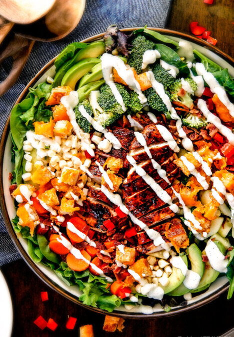 Preheat oven to 375 degrees. Using a large, sharp knife, trim ends; halve squash crosswise to separate bulb from neck. Peel with a vegetable peeler. Cut both pieces in half lengthwise. With a spoon, scoop out seeds; discard. Cut squash into 2-inch chunks; transfer to a small rimmed baking sheet. Toss with oil and sage; season generously with salt and pepper. Scatter garlic around squash. Roast until squash is very tender, about 40 minutes, tossing once halfway through. Remove and discard skin from garlic. Transfer squash and garlic to a food processor; puree. With motor running, add half-and-half through the feed tube; process until smooth. Add 1 to 2 cups water; continue to process until smooth, adding water to thin if necessary. Season again generously with salt. (To freeze, see below.) Cook pasta according to package instructions. Reserve 1 cup pasta water; drain pasta and return to pot. Pour sauce over pasta; toss to coat. Add some pasta water to thin sauce if necessary. Serve with desired toppings.