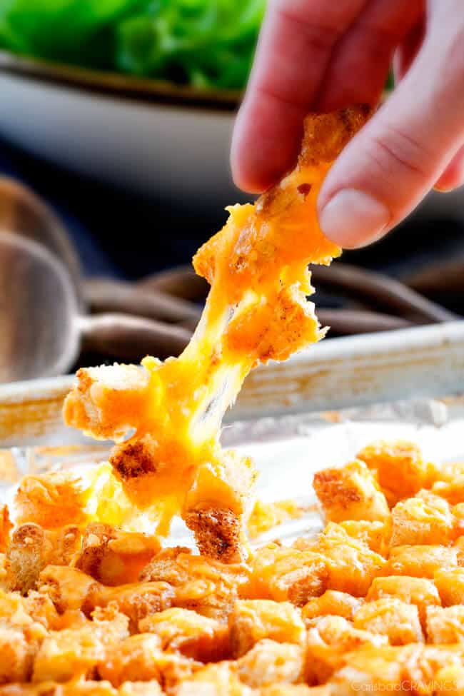 Showing how to make Bacon Ranch Chicken Salad by adding cheesy croutons.