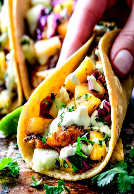 Mind blowing Blackened Fish Tacos with a quick marinade and the most flavorful spice rub! These are hands down the BEST FISH TACOS ever! And the sweet and tangy Pineapple Cucumber Slaw and Avocado Crema hit this one out of the park! seriously better than my favorite restaurant!