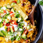 Creamy, Cheesy One Skillet Mexican Chicken and Rice on your table in 30 minutes! My family BEGS me to make this constantly and I LOVE it too! Quick, easy and packed with flavor and texture! We also love it as the base for taco salad. You definitely have to try this one!