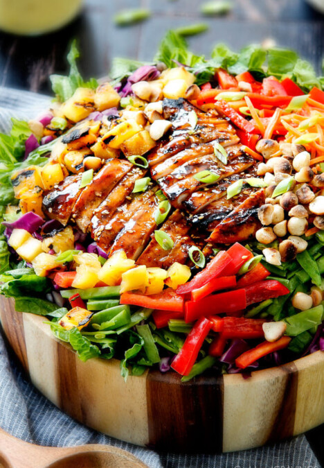 Teriyaki Chicken Salad - This salad is to live for! Packed with refreshing pineapple, macadamia nuts and coconut all doused with the most AMAZING Pineapple Sesame Dressing and the Sweet Chili Teriyaki Chicken is incredible! But my favorite part is you drizzle the leftover Teriyaki glaze all over the salad! Definitely a keeper!