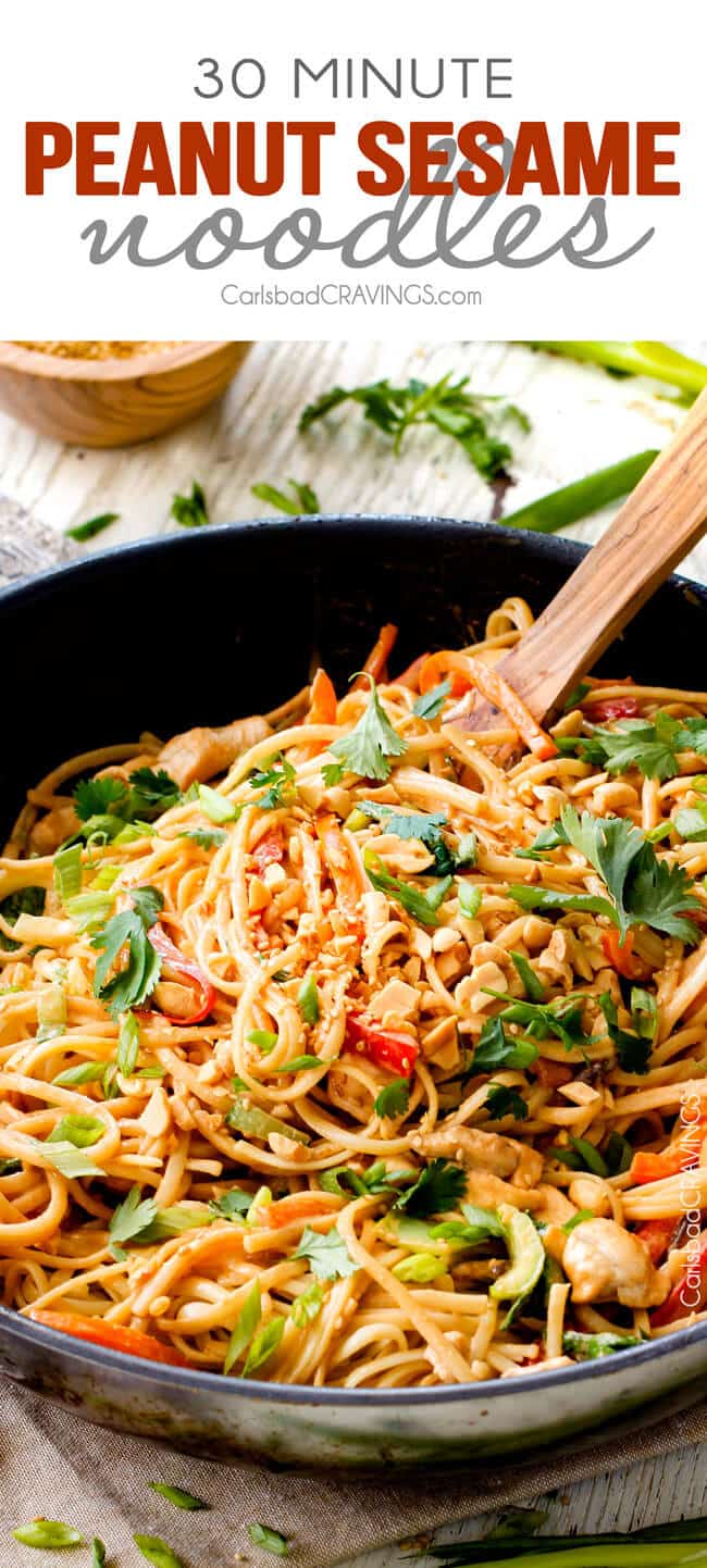 30 Minute Peanut Sesame Noodles (with Chicken and Veggies) - super quick and easy meal all in one with the most amazing creamy peanut sesame sauce you will crave for days! up close view of Sesame Noodles with Peanut Butter in a black skillet with chicken, and veggies