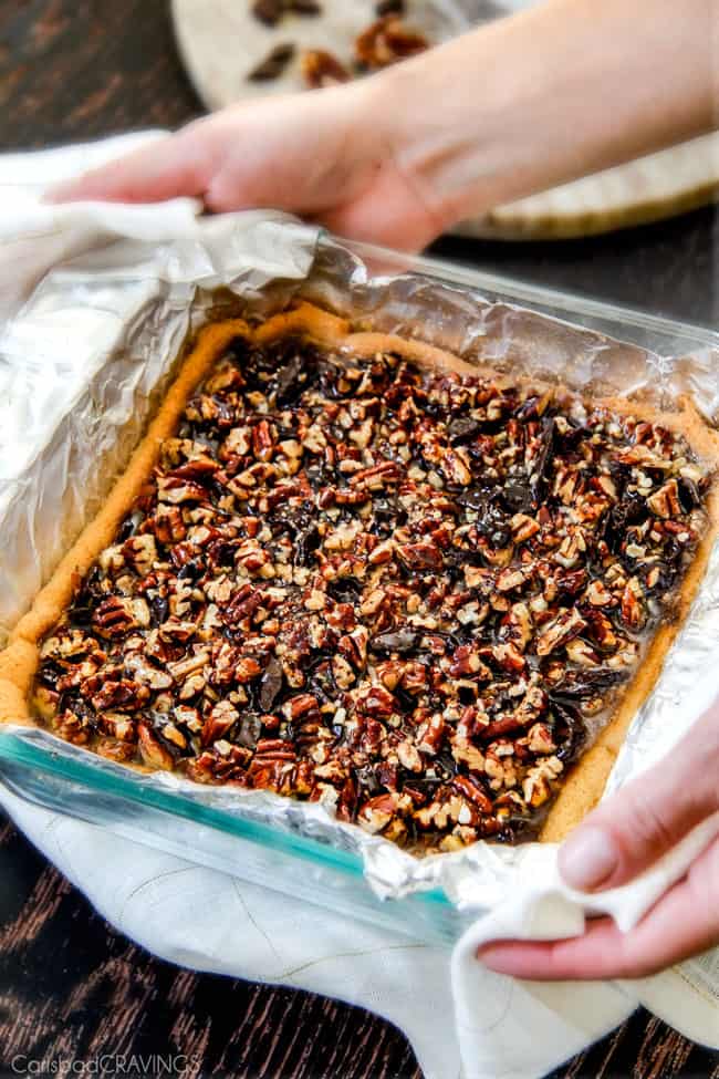 Showing how to make Chocolate Chunk Pecan Pie Bars by baking.