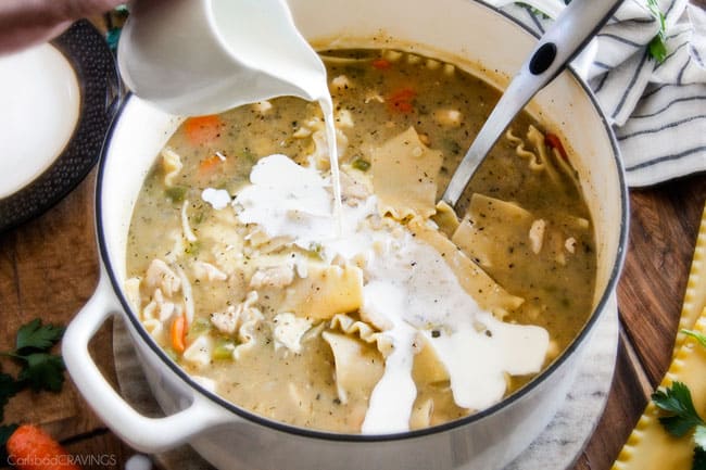 Showing how to make White Chicken Lasagna Soup adding cream to the pot.