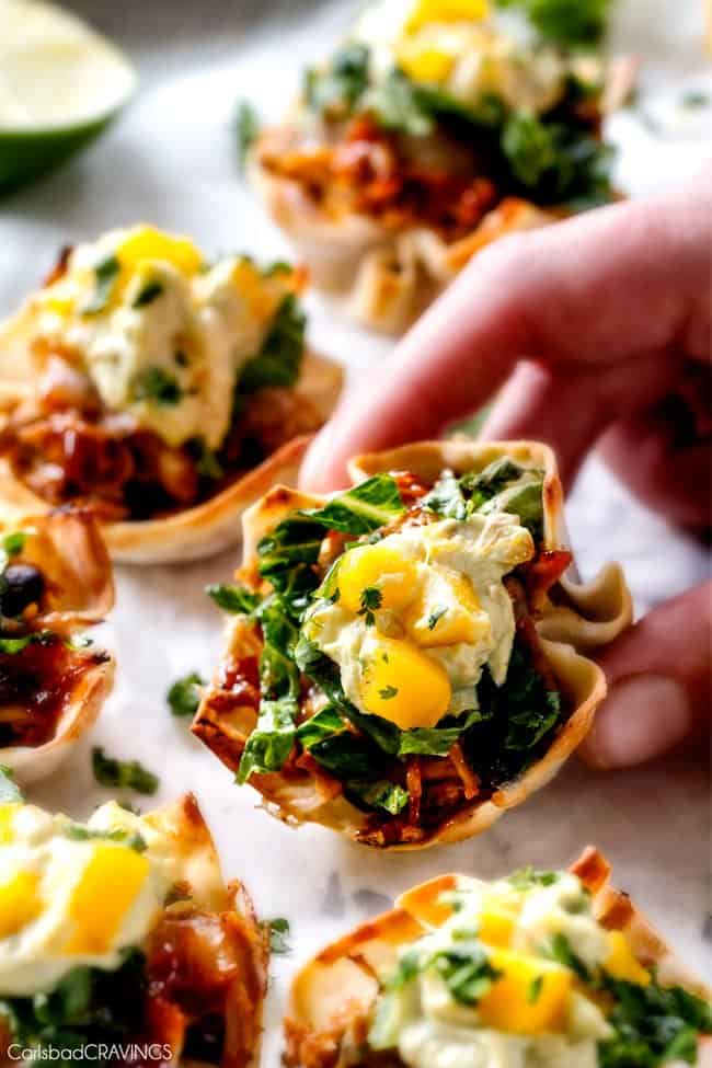 Holding a Salsa Verde Honey Lime Chicken Taco Cups.
