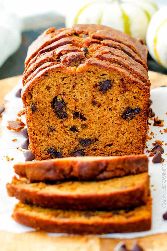 My Mom’s Famous Chocolate Chip Pumpkin Bread! So incredibly moist, infused with cinnamon, cloves and nutmeg with only 2 bowls and one whisk required! Everyone will BEG you for this recipe! front view of moist pumpkin bread with chocolate chips
