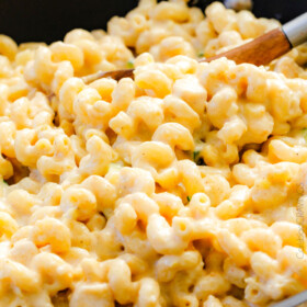 This mega creamy (lightened up) Salsa Verde Pepper Jack Macaroni and Cheese is crazy flavorful infused with salsa verde, pepper jack and sharp cheddar and super easy to make! A new family favorite on the table in under 30 minutes (including the option of chicken and veggies)!