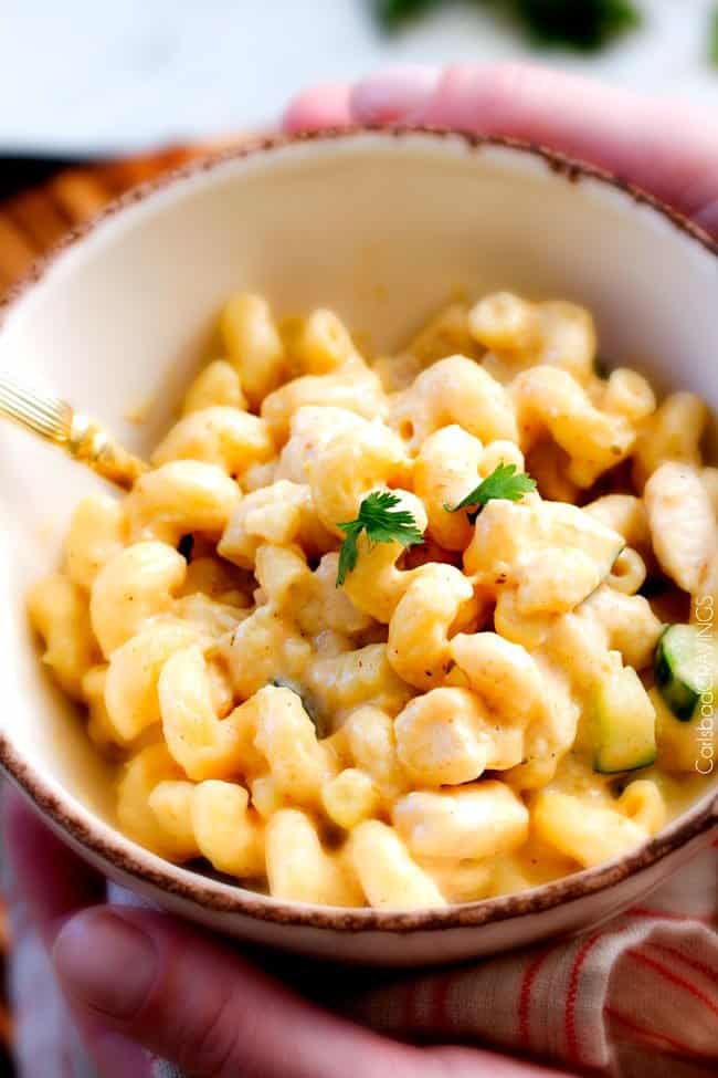 This mega creamy (lightened up) Salsa Verde Pepper Jack Macaroni and Cheese is crazy flavorful infused with salsa verde, pepper jack and sharp cheddar and super easy to make! A new family favorite on the table in under 30 minutes (including the option of chicken and veggies)!