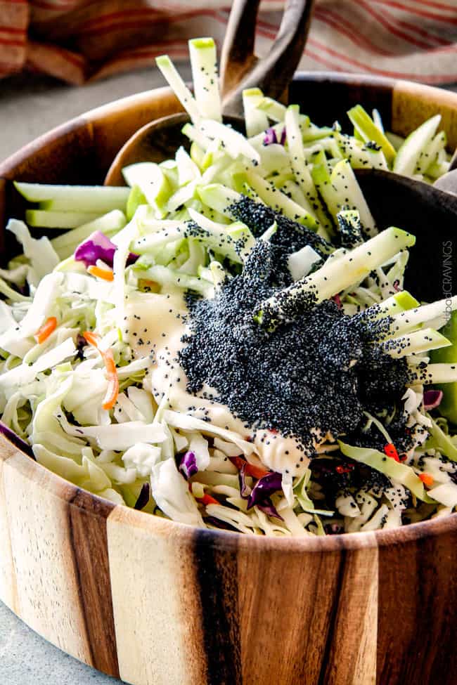 20 Minute Chipotle BBQ Cranberry Turkey Sliders (or chicken!) are a wonderfully delicious way to devour your Thanksgiving turkey leftovers or SO good you will want to make them forever and ever with chicken! And don’t skip the crunchy, sweet and tangy out of this world Apple Poppy Seed Slaw! showing how to make Thanksgiving turkey sliders by tossing coleslaw ingredients in a bowl