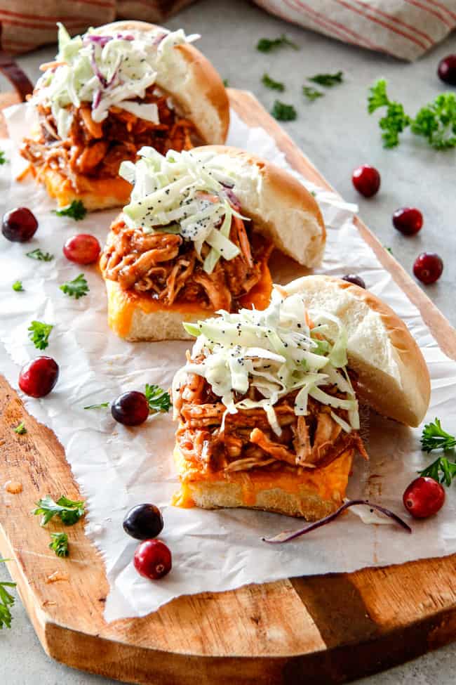 20 Minute Chipotle BBQ Cranberry Turkey Sliders (or chicken!) are a wonderfully delicious way to devour your Thanksgiving turkey leftovers or SO good you will want to make them forever and ever with chicken! And don’t skip the crunchy, sweet and tangy out of this world Apple Poppy Seed Slaw! Baked turkey sliders on a cutting board