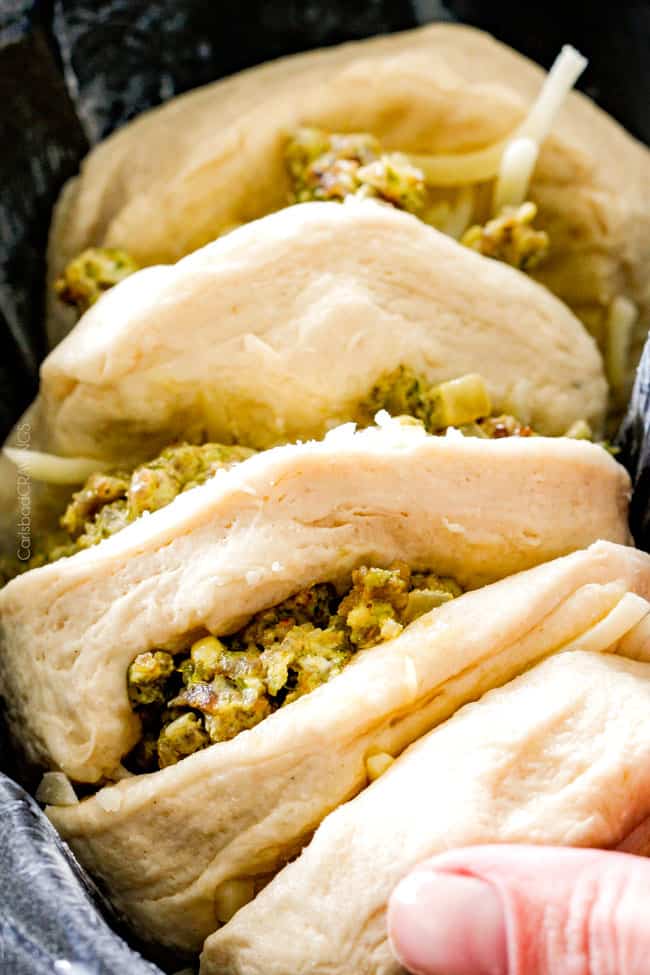 Showing how to make Cheesy Sausage Pesto Ring preparing to bake. 