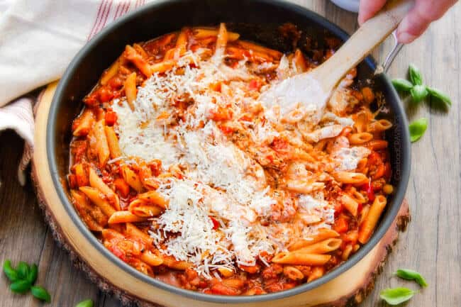 One Skillet Cheesy Penne - the best homemade ragu sauce simmered right with the pasta then loaded with cheese! My family begs me to make this weekly!