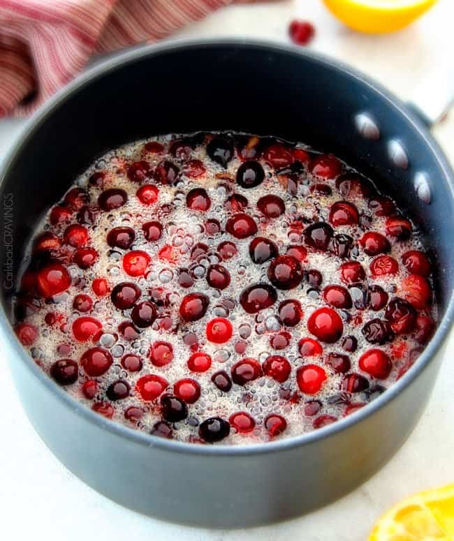 Showing how to make Pineapple Cranberry Sauce in a sauce pan.