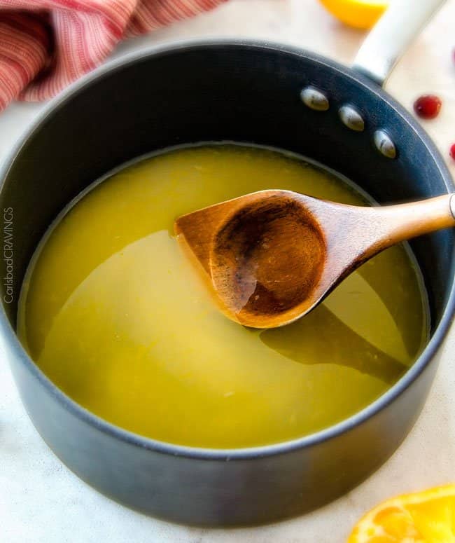 Showing how to make Pineapple Cranberry Sauce.
