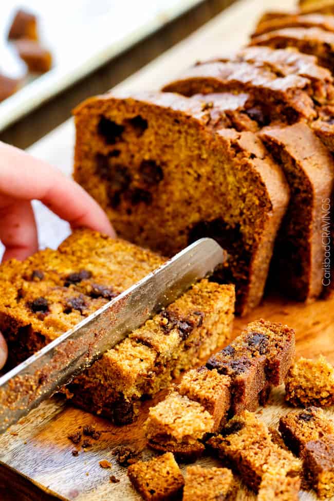 showing how to make pumpkin bread pudding by cubing pumpkin bread