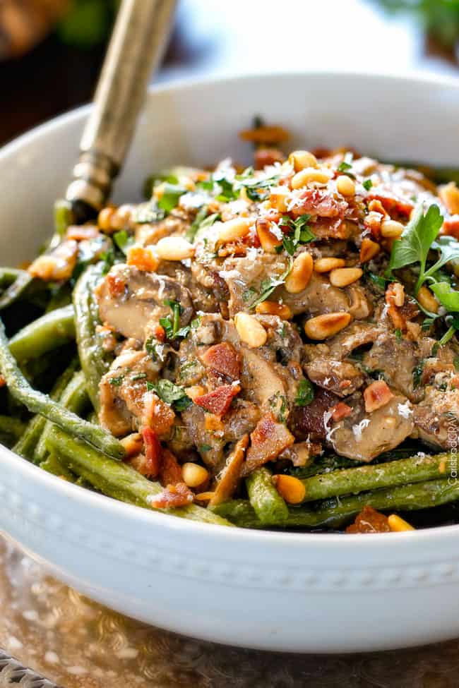 Roasted Green Beans with Cremini Bacon Mushroom Sauce - these beans are amazing! wonderfully flavorful, crisp tender and the silky Cremini Bacon Mushroom Sauce is out of this world! If you are looking for an alternative to green bean casserole, this is it! #thanksgiving up close of Roasted Green Beans with Bacon, Parmesan and pine nuts