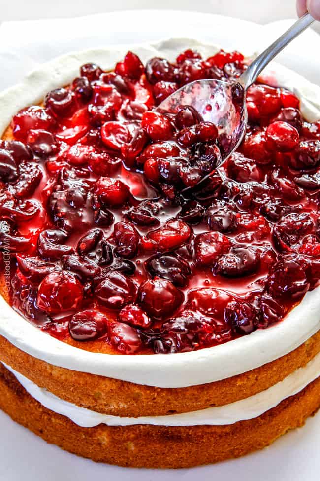 Showing how to assemble a cranberry cake.
