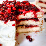 White Cake with Cranberry Filling and Buttercream Frosting – everyone always asks me for this recipe! The moist, bakery style white cake is the BEST ever and the sweet and tangy cranberry filling is melt in your mouth delicious and Christmas festive!