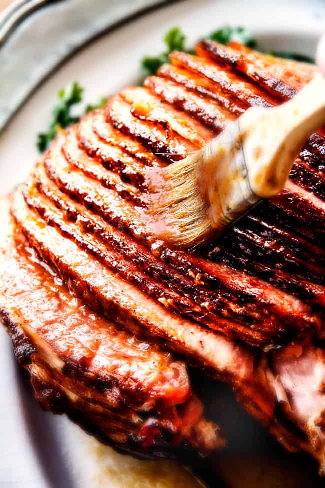 Showing how to add glaze to the Maple Glazed Ham with a brush